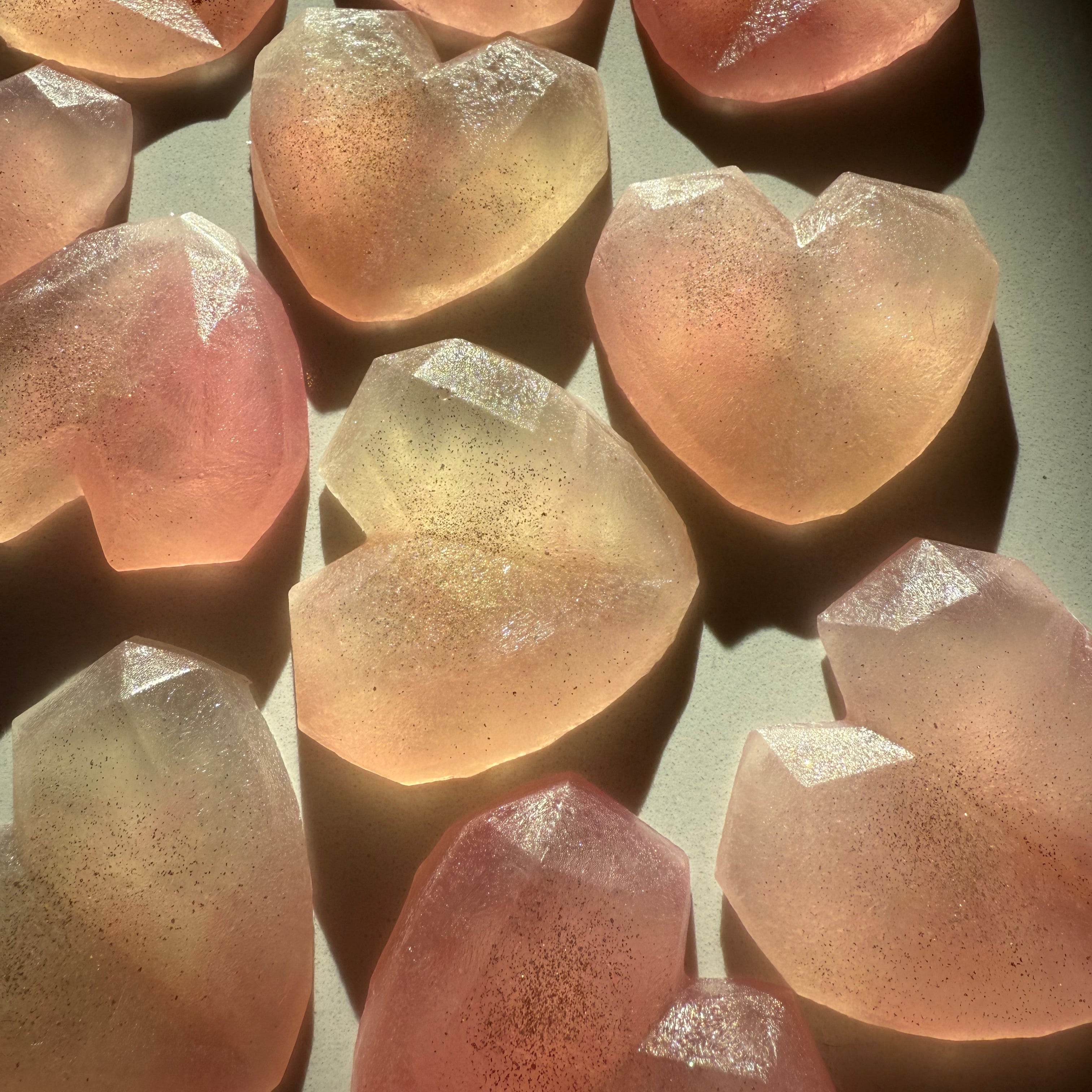 Close-up of translucent, pinkish-crystal candy  gemstones on a dark background
