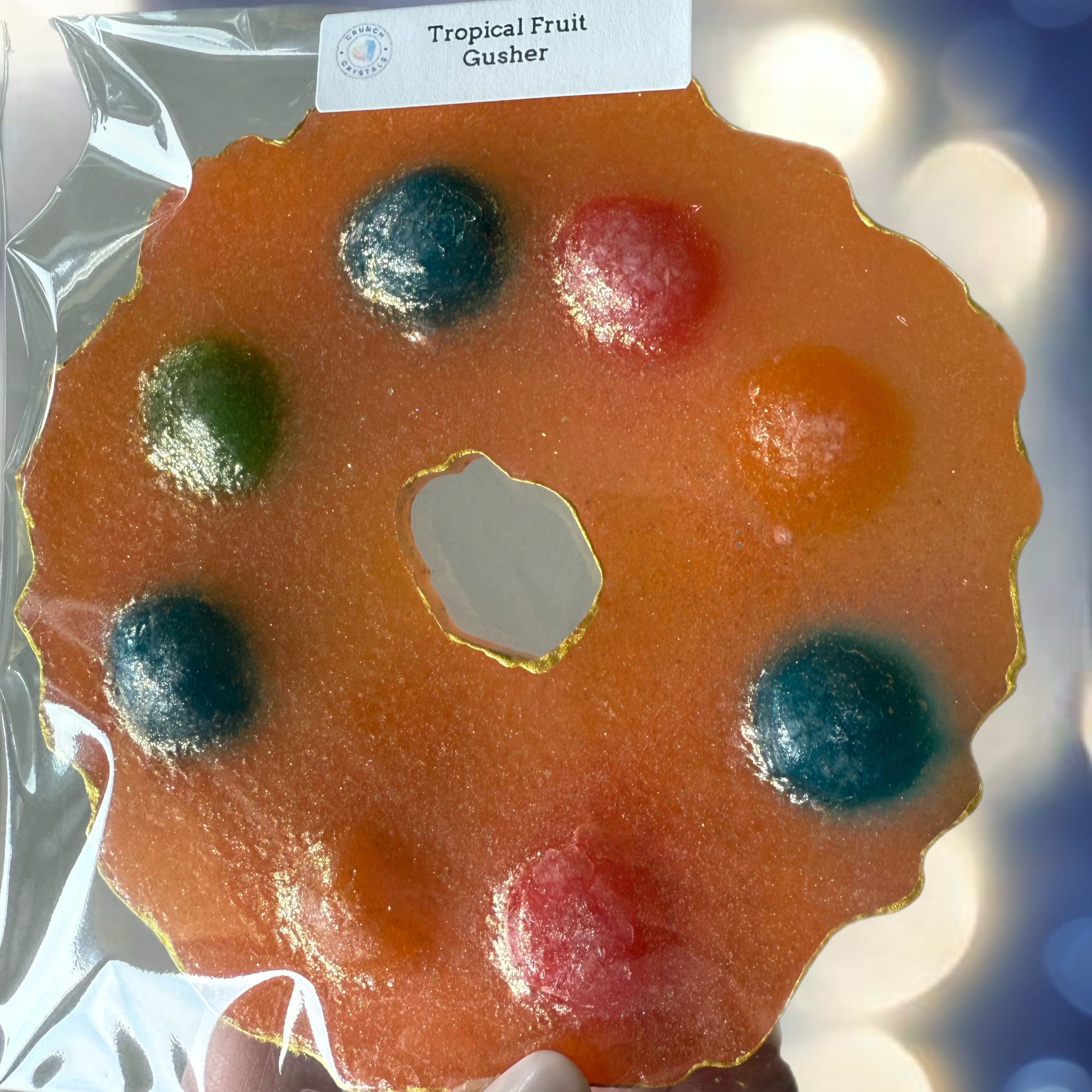 Tropical Fruit Gusher candy in a decorative holder with a blurred background